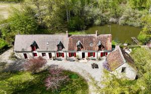 an aerial view of a large house with red doors at Le Fourneau Rond in Soings-en-Sologne
