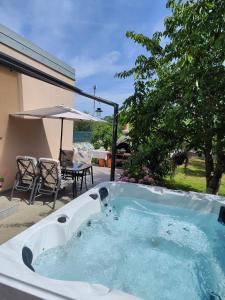 a jacuzzi tub in a yard with a table at Rooms Katarina in Poreč