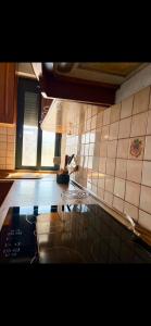 a kitchen with a stove and a tiled wall at Room 357 in Tirana +12 photos