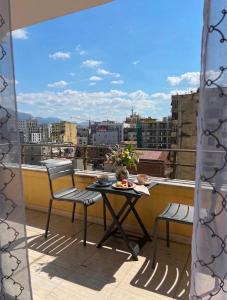 a table and chairs on a balcony with a view at Room 357 in Tirana