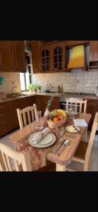 a kitchen with a table with a bowl of fruit at Room 357 in Tirana