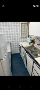 a small kitchen with a sink and a refrigerator at ,1 habitacion in Esplugues de Llobregat