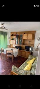 a living room with a couch and a table at ,1 habitacion in Esplugues de Llobregat