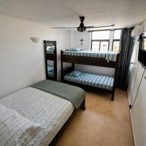 a bedroom with two bunk beds and a window at Troya 701 in Gaira