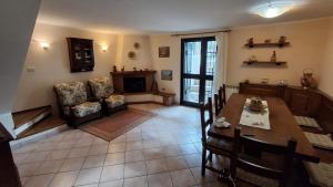 a living room with a table and a chair at Casa Bibi in Subbiano