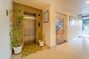 an elevator lobby with plants and a colorful rug at Treebo Premium Lavender Kochi Infopark in Cochin