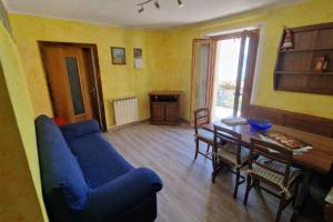 a living room with a blue couch and a table at casa Belvedere in San Siro +29 photos