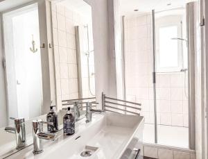 a white bathroom with a sink and a mirror at Seebühnenblick in Seeham +37 photos