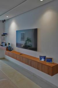 a large flat screen tv on a wall in a lobby at InHome Apartment F2 in Cabo Negro +33 photos