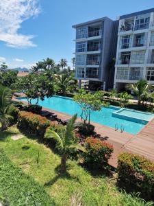 a large apartment building with a large swimming pool at Eid and Philippe's Home building A9 in Ban Ko Kwang