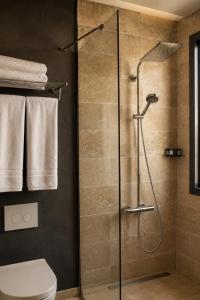 a bathroom with a shower with a toilet and towels at Life Butiq Otel in Yalıkavak +195 photos