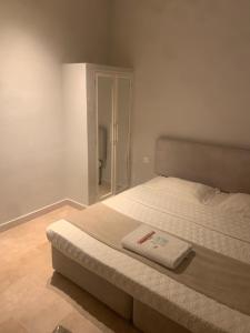 a bedroom with a bed and a mirror at Hotel room in Salalah