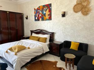 a bedroom with a large bed and a couch at Beach apartment down town in Agadir
