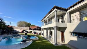 a house with a swimming pool in the yard at Nyasa Villa in Southgate