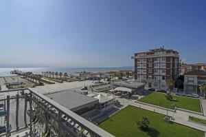 a view of a city with a building and the ocean at Hotel Nuovo Tirreno in Lido di Camaiore