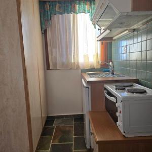 a small kitchen with a stove and a window at Marmari Sunset View in Marmari +9 photos