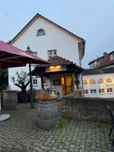 a building with a wine barrel in front of it at Bartenwetzer Schleusenhaus 1 in Melsungen