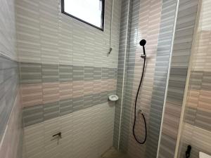 a bathroom with a shower with a glass door at Krabi Buddy House in Ban Khlong Chi Lat