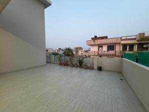 an empty balcony of a building with plants at Entire 2Bhk Flat with a big Balcony in Jaipur