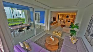 a living room with a purple couch and a table at InHome Apartment F2 in Cabo Negro