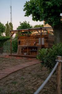 a wooden building with a pergola in a yard at Le Bunker Secret - Logement Insolite in Florensac