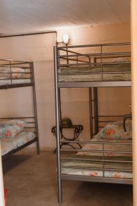 a bunk bed room with three bunk beds in it at Le Bunker Secret - Logement Insolite in Florensac