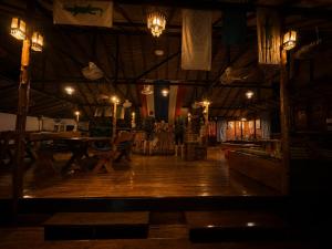 a large room with a wooden floor and lights at Vanara Resort in Ko Chang