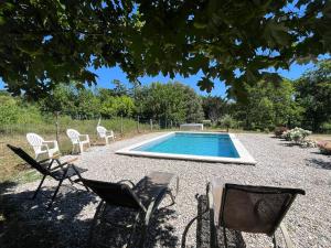 a group of chairs sitting around a swimming pool at Gîte des Lauriers Roses in Laurac-en-Vivarais