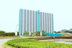 a large white building in front of a building at Reverdale in Bekasi