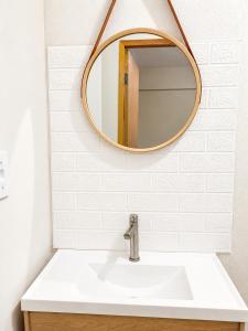 a bathroom with a sink and a mirror at Hotel Confort in Quixadá