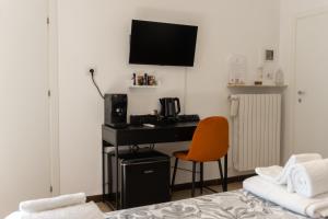 a bedroom with a desk with a computer and a chair at Room in Bloom Bed and Breakfast in Terlizzi