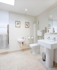 a white bathroom with a sink and a toilet at The Talbot Hotel in Ledbury