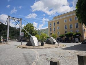 a sculpture in a courtyard in front of a building at Monica Donau in Passau