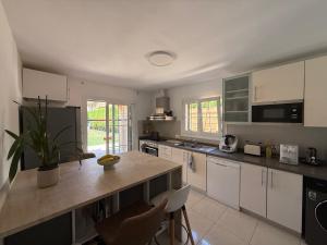 a kitchen with white cabinets and a counter top at Villa Mares Puig in Llucmajor