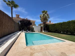 a swimming pool in the backyard of a house at Villa Mares Puig in Llucmajor