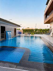 a large swimming pool with a water fountain on a building at Vianara's Eco Feel Resort in Jaipur
