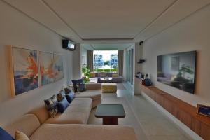 a living room with a couch and a tv at InHome Apartment F2 in Cabo Negro