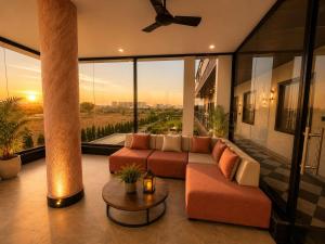 a living room with a couch and a table at Vianara's Eco Feel Resort in Jaipur