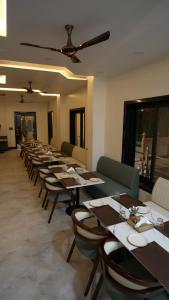 a row of tables in a dining room at Vianara's Eco Feel Resort in Jaipur