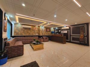 a living room with a couch and a table at Hotel Decent Premier Suites Near Delhi Aerocity in New Delhi