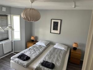 a bedroom with two beds and a chandelier at Toarp Inn free parking in Malmö