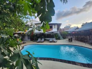 a large swimming pool in front of a house at TRR3 Apt near Beach with Fine Cuisine & Pool in Grand-Baie