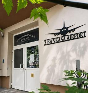 a sign on the side of a building with a airplane on it at 3 Baneasa Airport in Bucharest