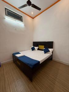 a bedroom with a bed with a ceiling fan at Shri Raghuveer guest house in Ayodhya