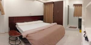 a bedroom with a large bed in a room at BVR Dazzle Residency in Avanigadda +20 photos