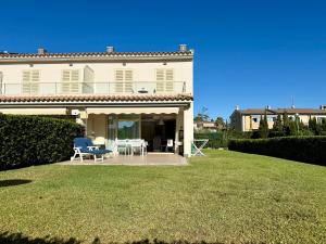 a large white house with a lawn in front of it at Villa Dulce in Port d'Alcudia