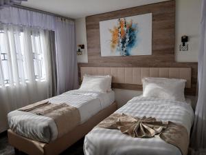 two beds sitting next to each other in a bedroom at ACK St.Julians Centre in Limuru