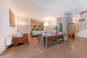 a living room with a table and chairs at Hotel Riva del Sole in Marina di Campo