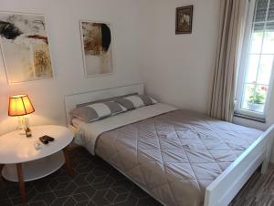 a bedroom with a bed and a table with a lamp at VA vikendica Tesanj in Tešanj +19 photos