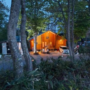 a group of people sitting in front of a tent at Private Villa Utan in Iiyama